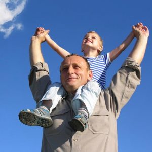 boy on fathers shoulders